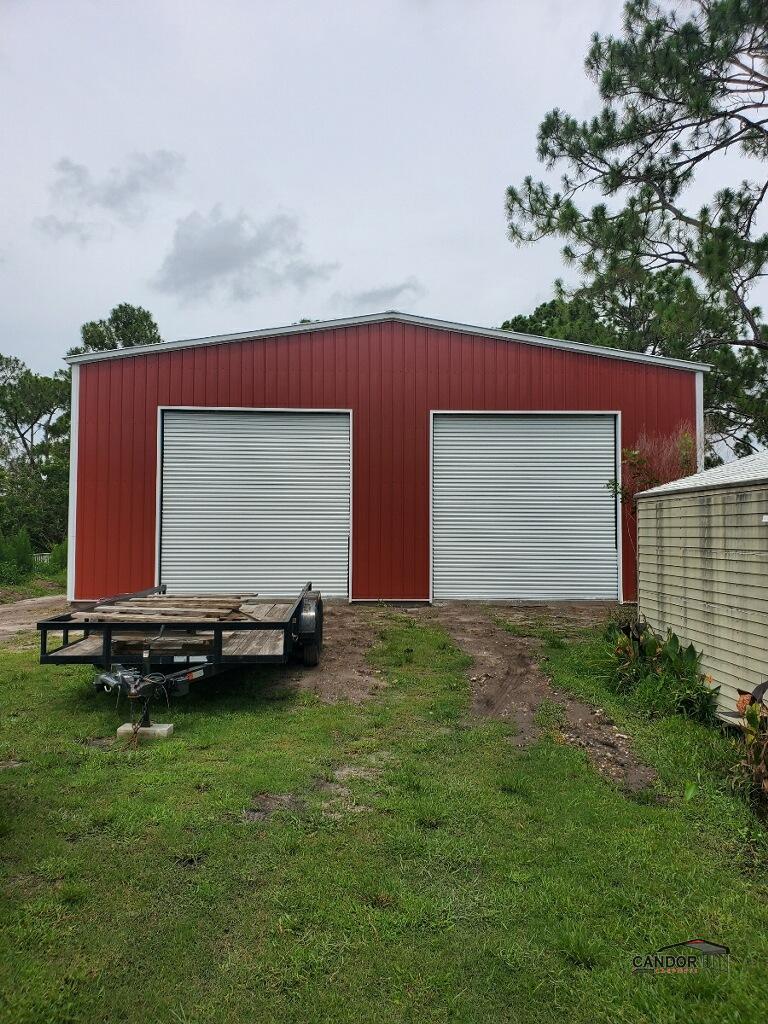 40'w x 60'd x 14'h Vertical Roof and Vertical Sides with 2 12'x12' Roll-Ups